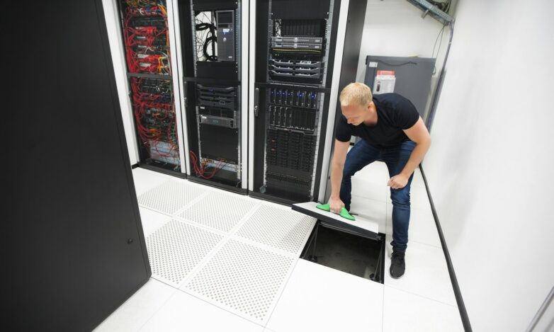 Computer Engineer Lifting Floor Tile Using Suction Cups In Datac Computer Engineer Lifting Floor Tile Using Suction Cups In Datac