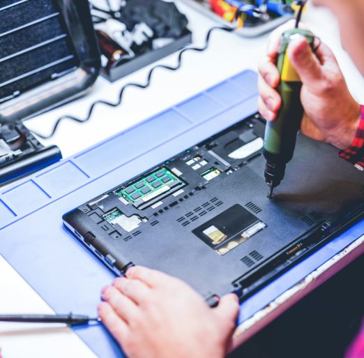IT engineer technician repairing computer in electronics service shop IT engineer technician repairing computer in electronics service shop
