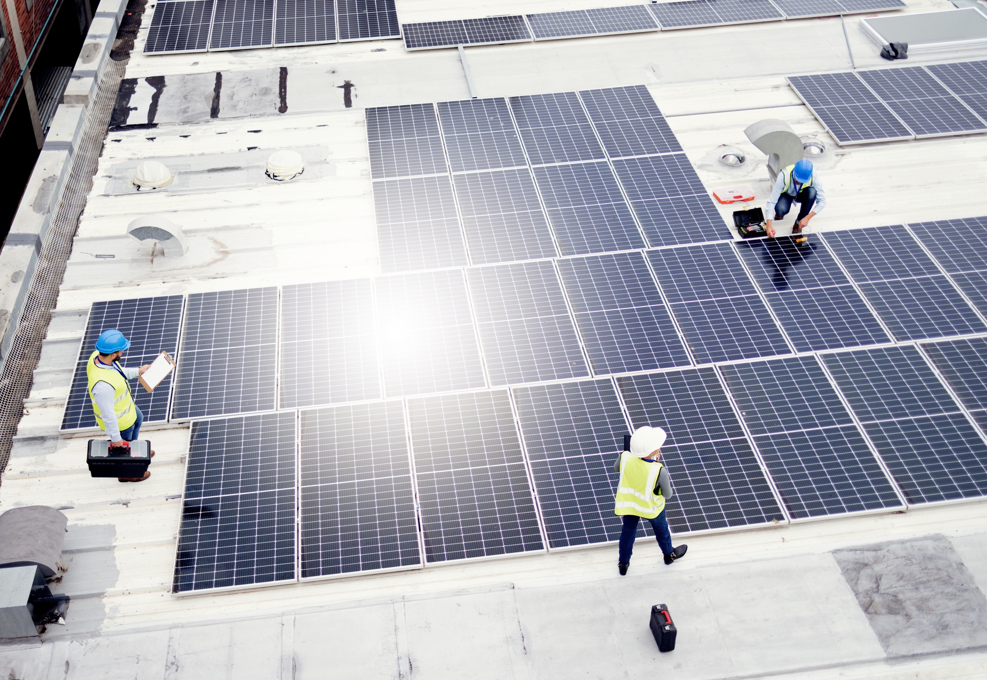 Solar energy, construction and employees building solar panels in collaboration for sustainability,